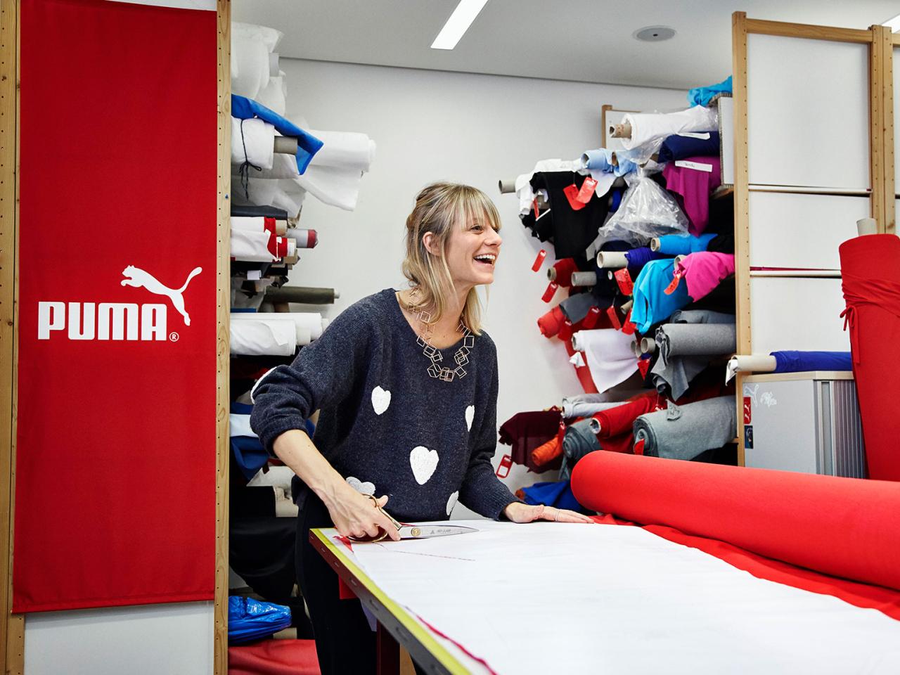 PUMA employee cuts out a piece of fabric