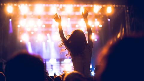 Stimmungsbild für Get the Look: Festival Looks 2025. Zeigt die Silhouette einer Frau in der Menge